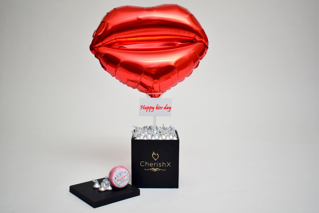  Chocolate Kisses For Valentine’s Day Gifts featuring a bucket with a lip shaped balloon 