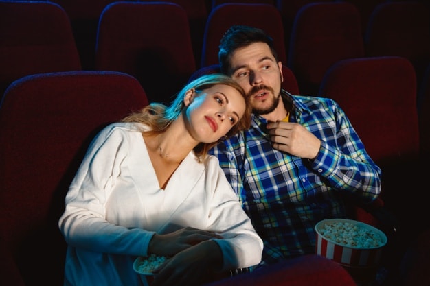11 Wonderful Ways to Celebrate Valentine’s Day in 2021-attractive-young-couple-watching-film-movie-theater_155003-19850