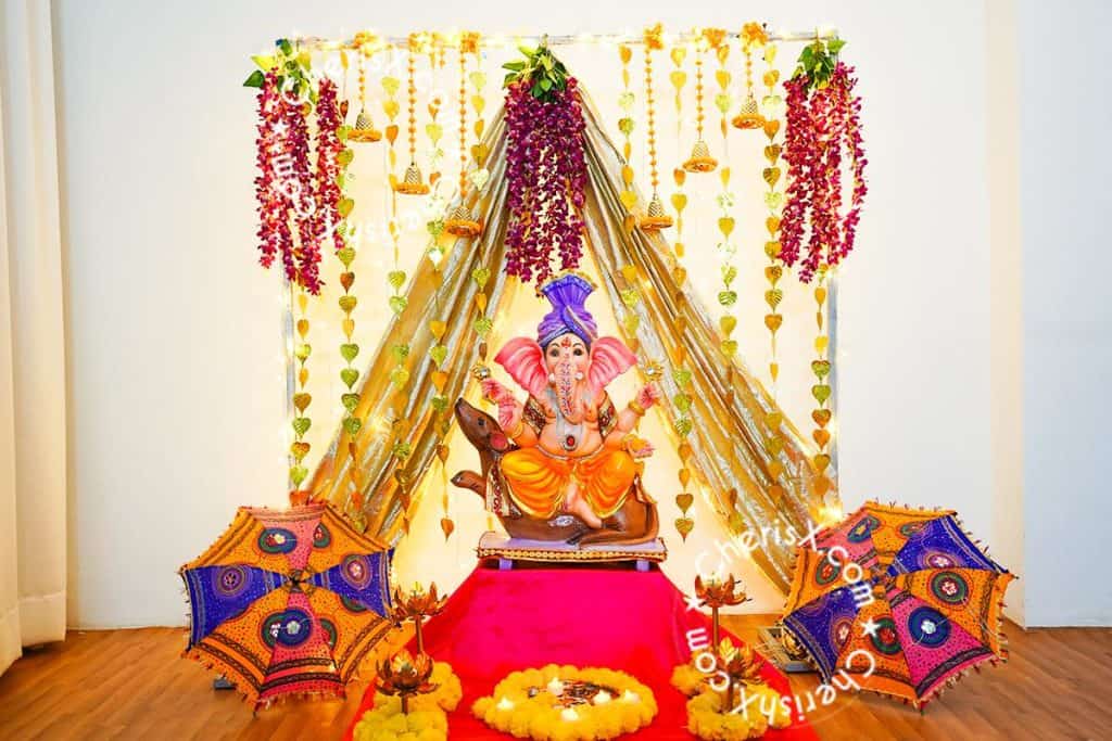 ganesh chaturthi decorations with led lights and fabric in backdrop