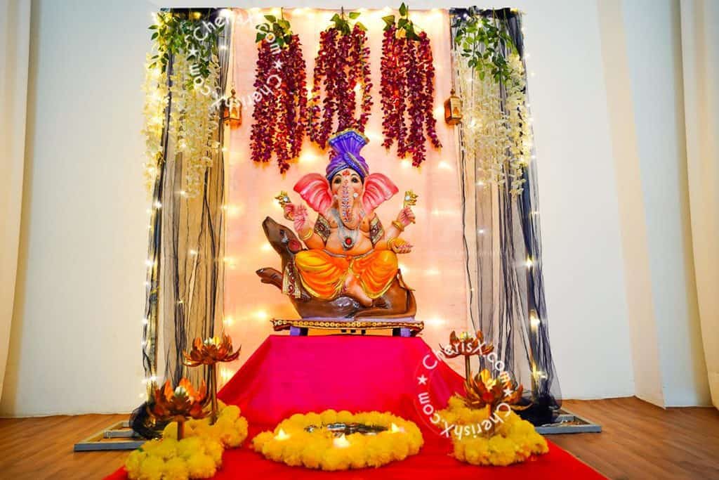 Ganpati decorations at home with LED lights and artificial flowers. 