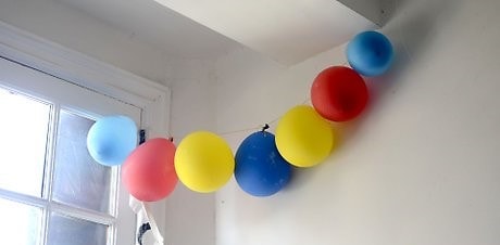 fishing line balloon garland on ceiling