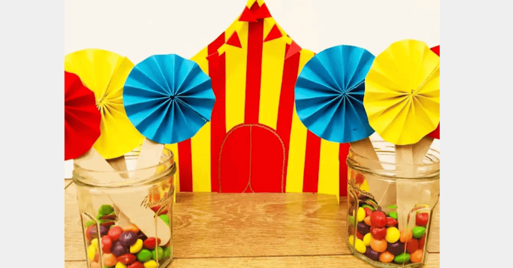Carnival theme table decoration with red and yellow paper cut-outs. 