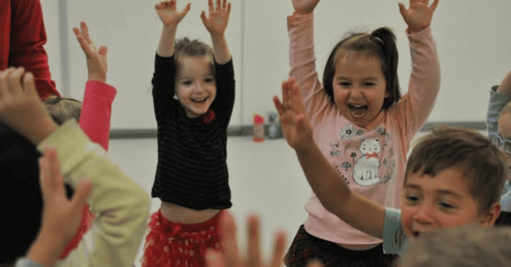 kids dancing together on a birthday party 