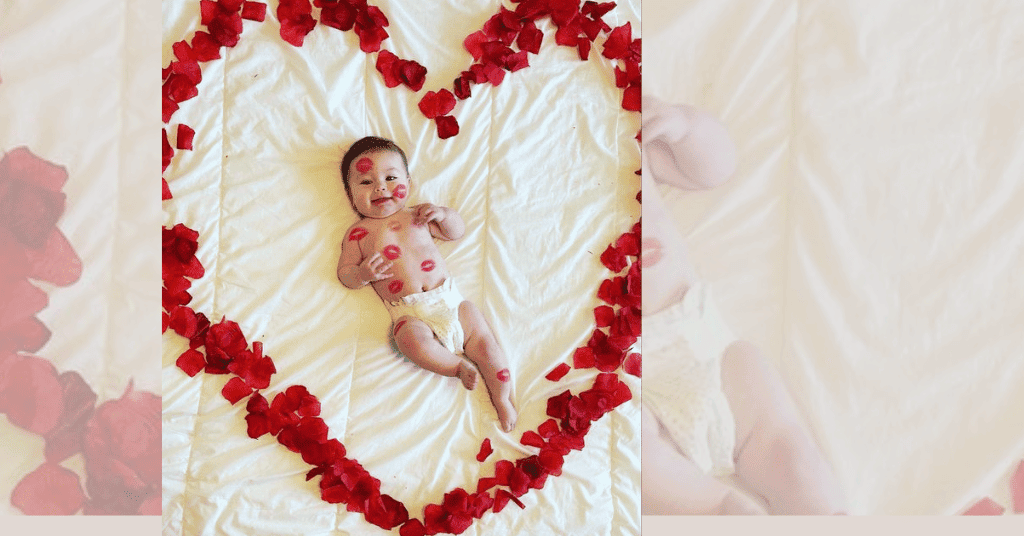 sweet 1st birthday photo: Child adorned with kisses and surrounded by heart-shaped rose petals, symbolizing love and warmth.