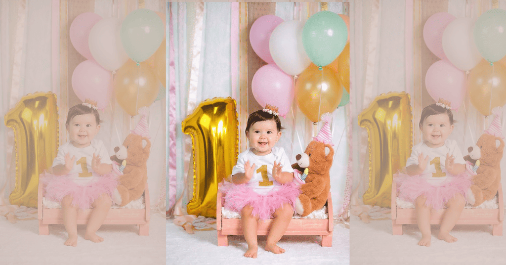 Joyful 1st birthday photoshoot of child seated with '1' foil number and vibrant balloons."