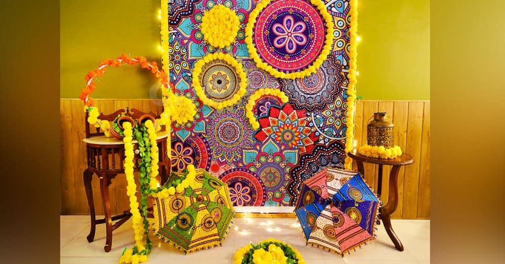 A pretty Mandala flex backdrop with artificial marigold flowers for Ganpati decorations 