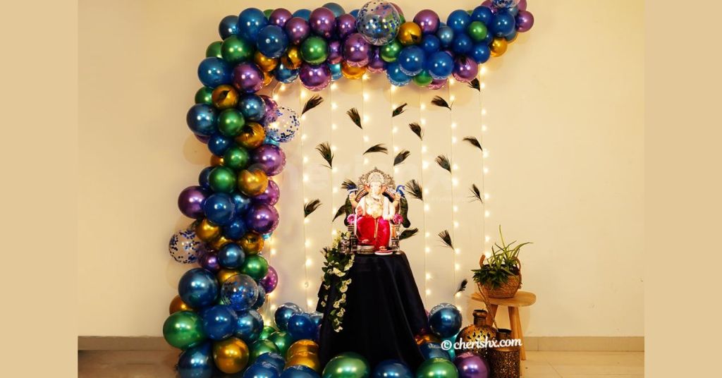 Ganpati Decoration with Peacock Feather and chrome balloons. 