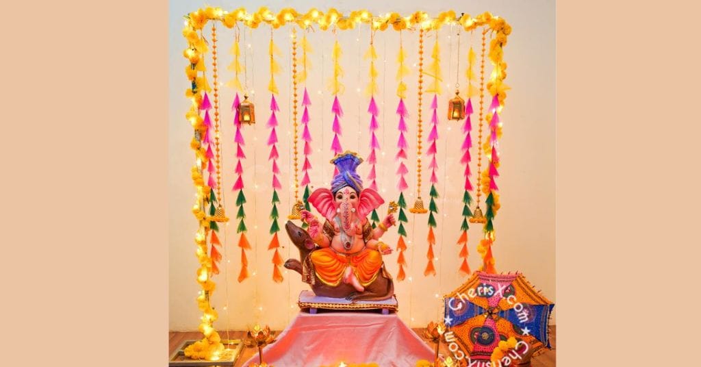 Pink, yellow, and orange tassels with LED lights for Ganpati decorations at home 