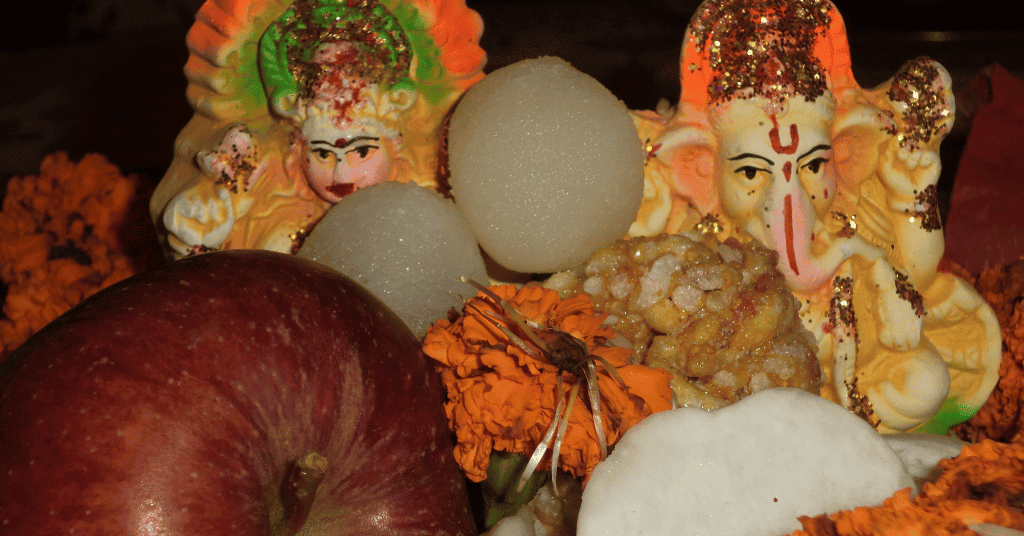 laxmi maa and ganesh ji offered with sweets and flowers 