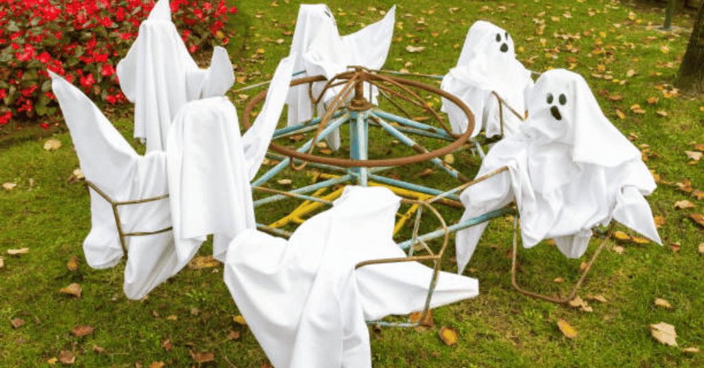 diy halloween cemetery decorations with white cloth to make ghost figures 