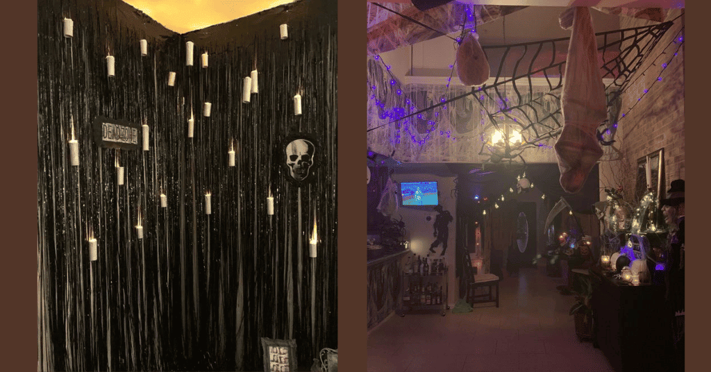 halloween party decoration ideas with black foil fringe, blue lights, spider web, and upside down hanged fake dead bodies. 