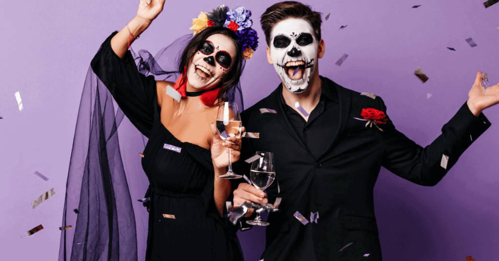 couple witch costume with spooky makeup on face with white and black paint 