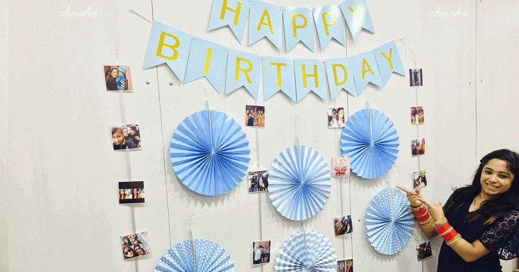paper decoration room with rosettes, happy birthday bunting, and hanging photos