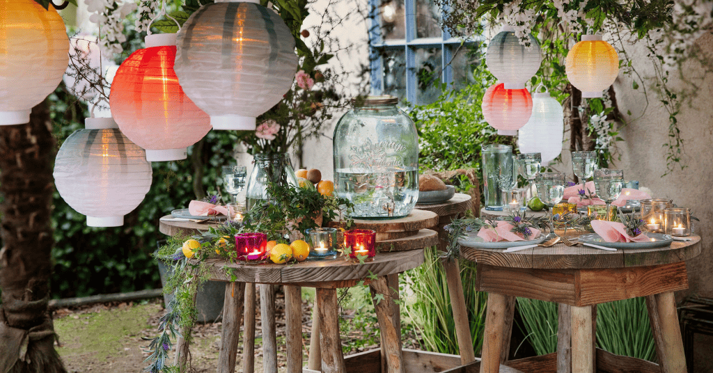 birthday decor without balloons featuring paper lanterns, plants, and wreaths. 