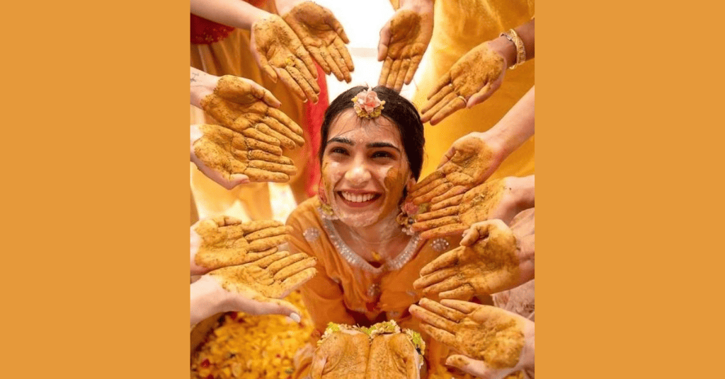 A bride to be smiling for the Haldi photo 